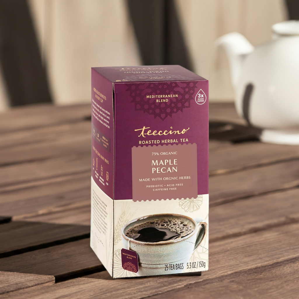 A single Monstera leaf in a clear glass vase against a white background.