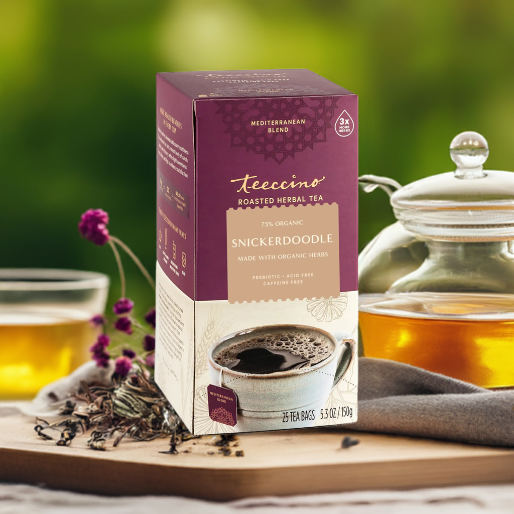 A single Monstera leaf in a clear glass vase against a white background.
