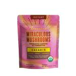 Front-facing pouch of Teecino Instant Miraculous Mushrooms Cacao +5 on a transparent background. The packaging features a warm terracotta upper section with the Teecino logo and “Mushroom Coffee Alternative” label. A central panel highlights Instant Miraculous Mushrooms with Cacao +5, listing turkey tail, cordyceps, reishi, chaga, and lion’s mane. The lower cream section notes low caffeine and prebiotic benefits, includes a USDA Organic seal, and shows a net weight of 4.76 ounces.
